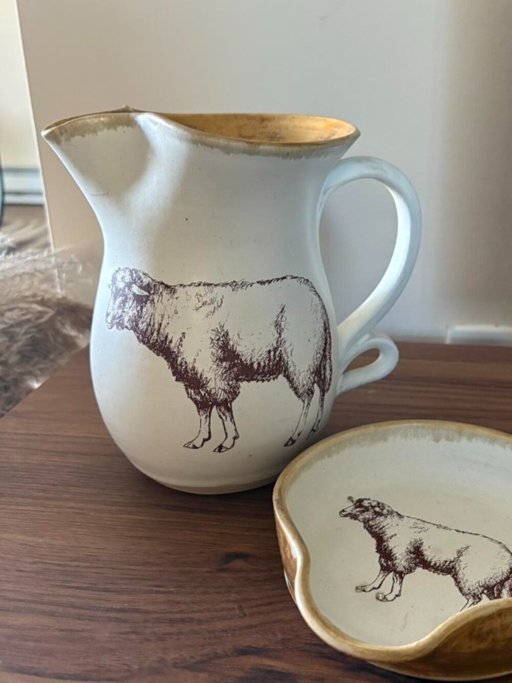 Cream and brown ceramic sheep pitcher and spoon rest